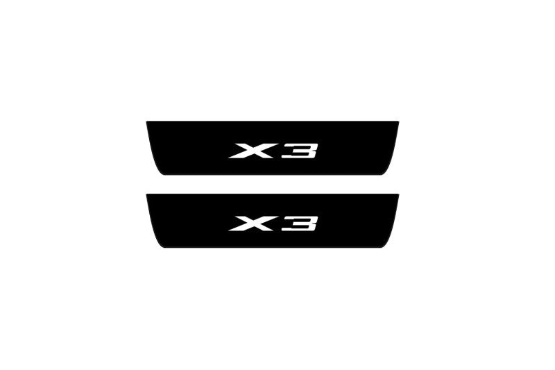 Catalog illustration of two black rear door sill plates with X3 lettering.