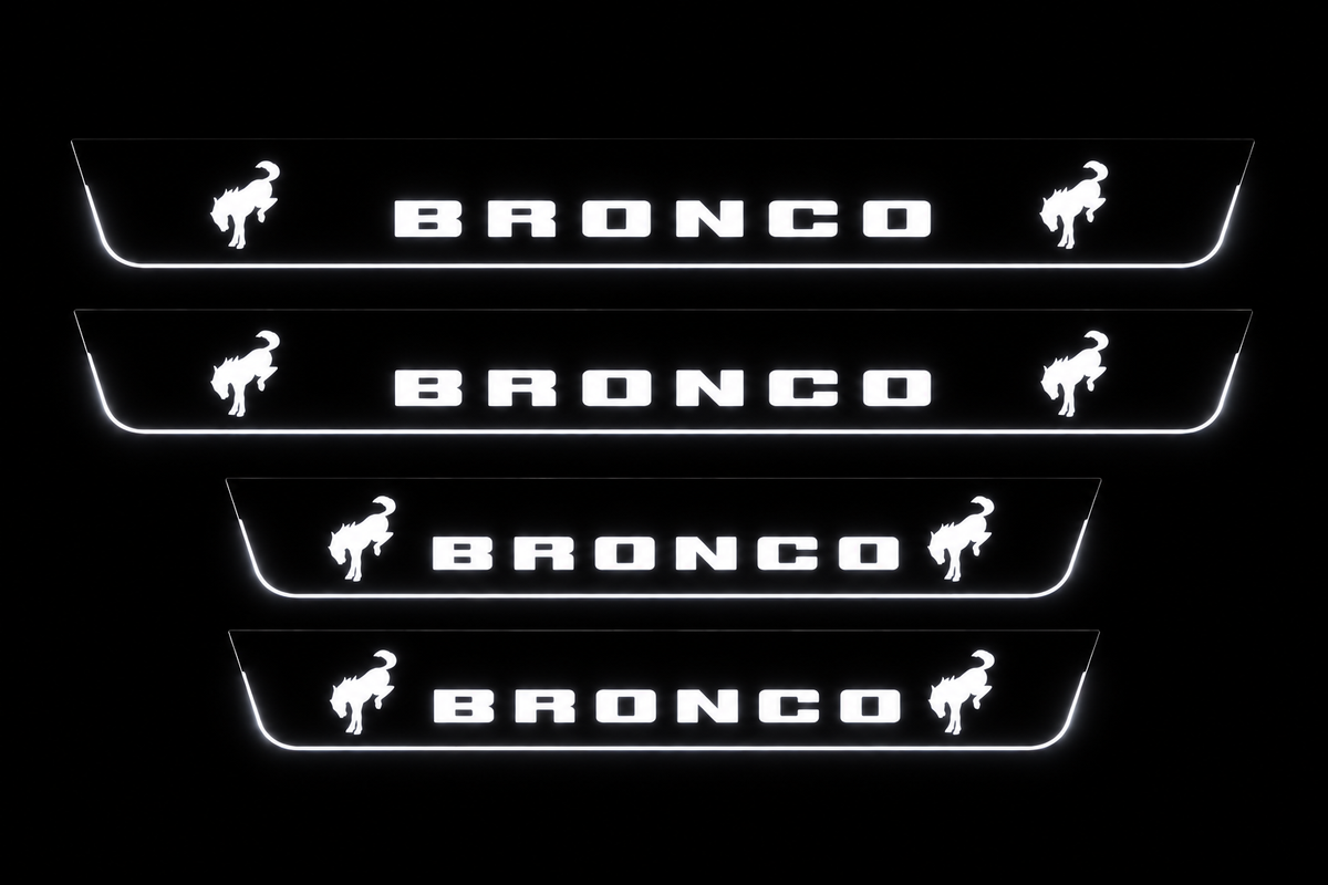 Product visualization: four flat Bronco plates, two front two rear, two horses on each. Black night background, unlit stainless face nearly hidden, white illuminated artwork, bars and real side/end edges with soft glow.