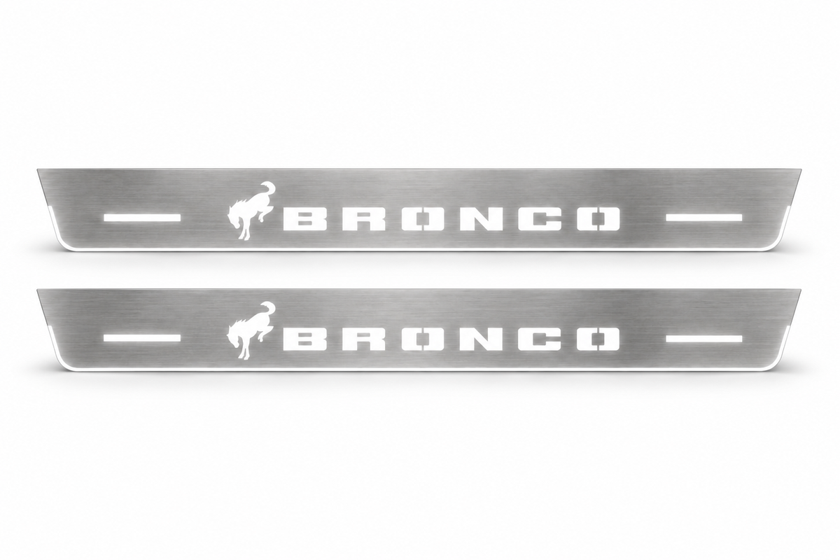 Product visualization: two Ford Bronco FRONT, exact one horse and stencil logo flat brushed stainless steel door sill plates with white LED artwork and edges, white background.