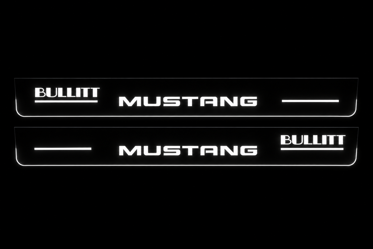 Product visualization: two flat bullitt-mustang-offset Stainless front plates with original source lettering and white LED zones flat brushed stainless steel door sill plates with white LED artwork and edges, dark background.