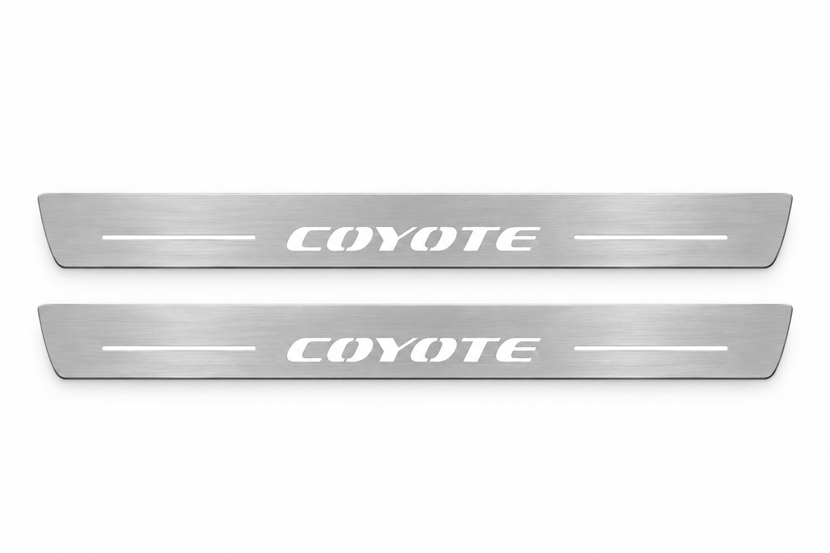 Product visualization: two flat original coyote-s197 Stainless front plates with exact artwork and white lower/end LEDs flat brushed stainless steel door sill plates with white LED artwork and edges, white background.
