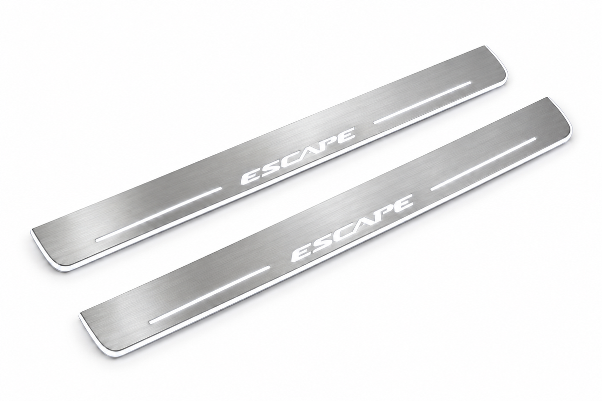 Product visualization: ESCAPE exact source wordmark, two flat front plates flat brushed stainless steel door sill plates with white LED artwork and edges, white background.