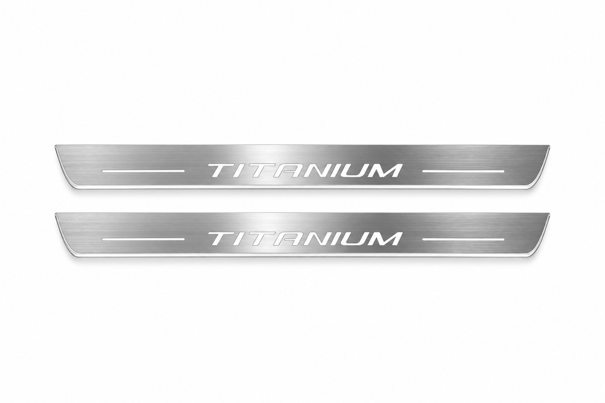 Product visualization: two exact Kuga Titanium front plates, own slender contour and artwork flat brushed stainless steel door sill plates with white LED artwork and edges, white background.