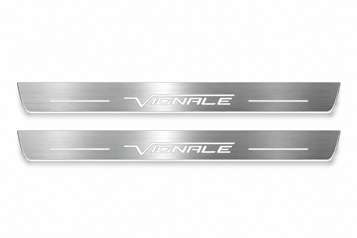 Product visualization: two exact Mondeo Vignale front plates, slender original outline and logo; black main hidden metal/white LED, white secondary visible silver flat brushed stainless steel door sill plates with white LED artwork and edges, white background.