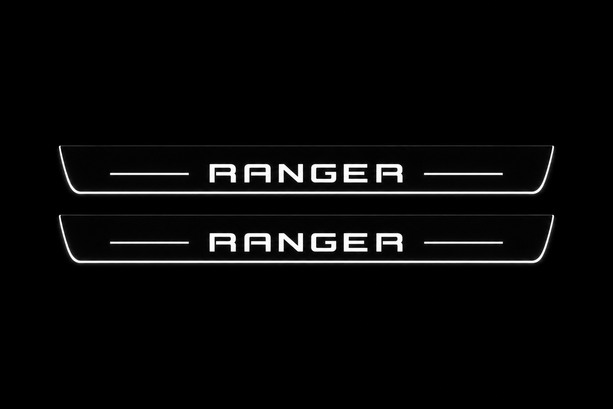 Product visualization: two flat front plates with original RANGER squared block lettering and side bars flat brushed stainless steel door sill plates with white LED artwork and edges, dark background.
