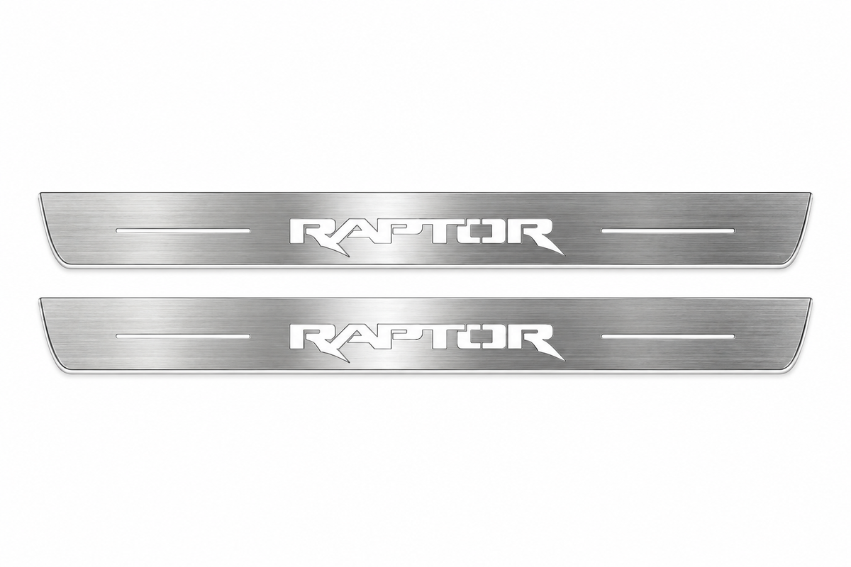 Product visualization: two flat Stainless front plates with exact RAPTOR angular logo and side bars flat brushed stainless steel door sill plates with white LED artwork and edges, white background.
