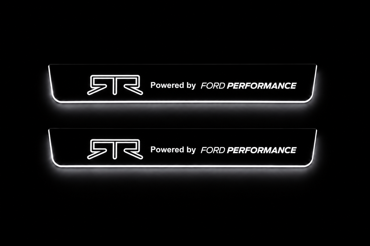 Product visualization: two flat front Stainless steel door sill plates, RTR and Powered by FORD PERFORMANCE artwork, white illuminated artwork and edges on a black night background. Front Pair.