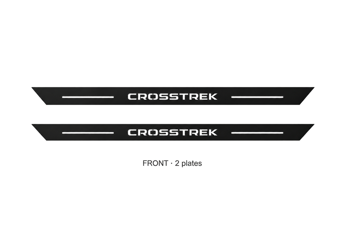 Catalogue illustration: FRONT only — two black Matte PRO front plates with CROSSTREK lettering illuminated on top. Rear plates offered in FRONT+REAR are not pictured; vehicle-specific dimensions are not depicted.