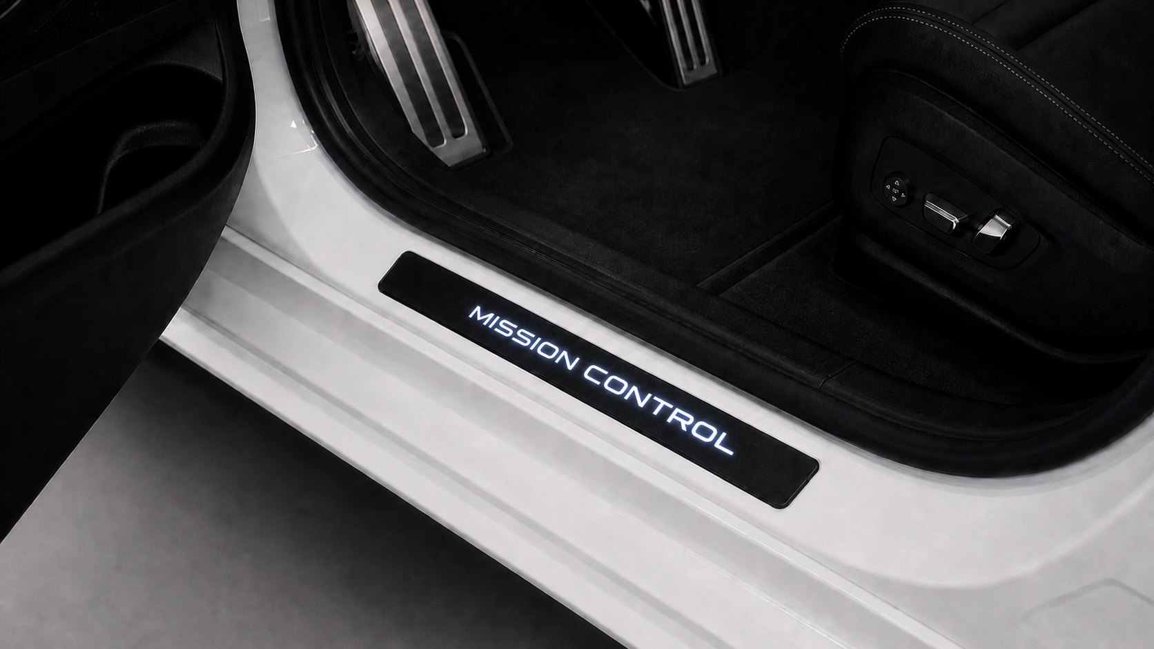 The same vehicle scene with a MISSION CONTROL illuminated door sill