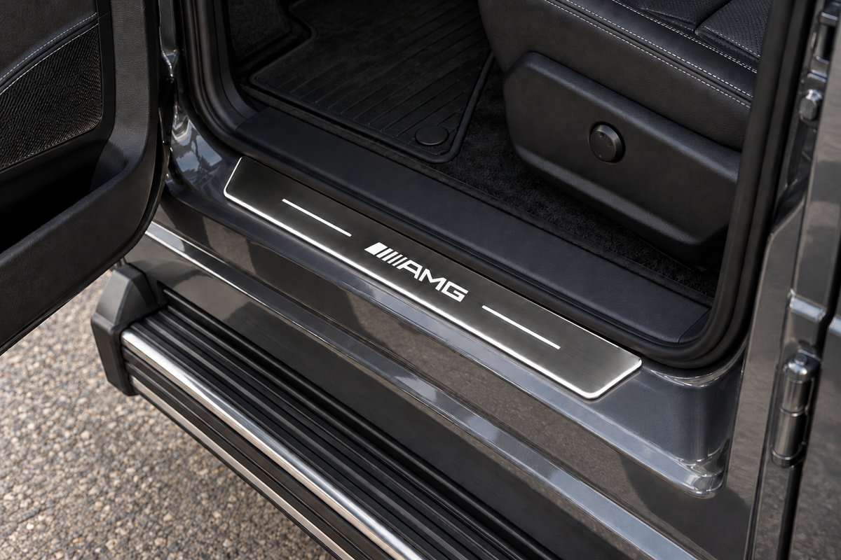 Mercedes G-Class AMG Stainless sill visualization directly against the rubber seal on exposed horizontal grey metal, white AMG artwork, bars and thin edge illumination.
