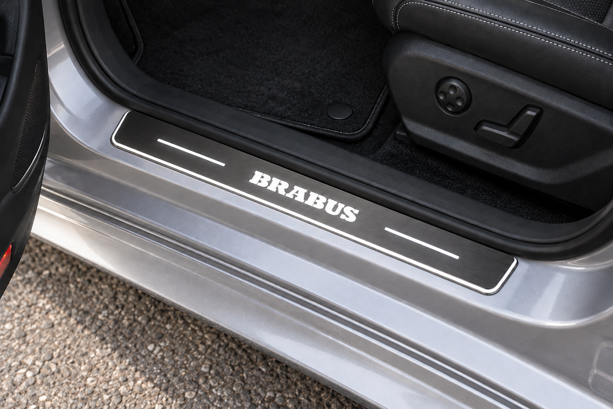 BRABUS Stainless sill with white lettering, light bars and edge illumination on grey metal directly against rubber seal — product visualization