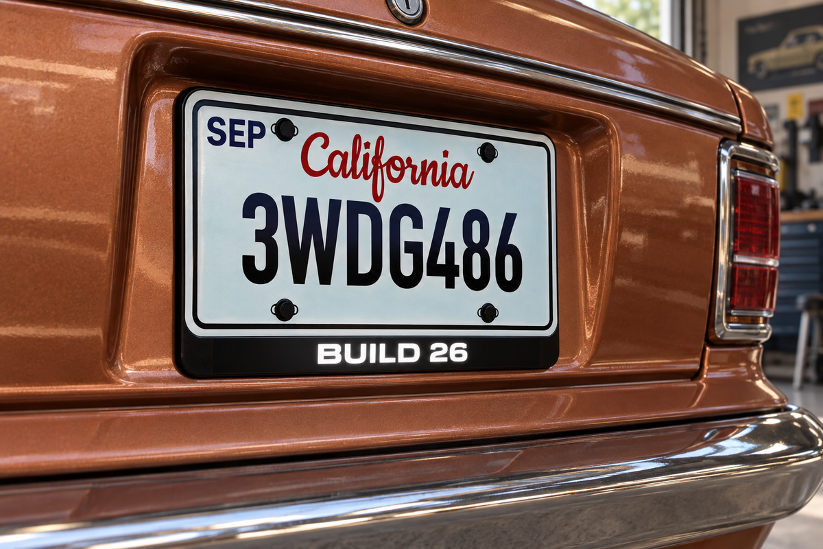 Custom-text concept showing BUILD 26 in white below an illustrative plate on a copper car; based on the real badge structure, subject to artwork review.