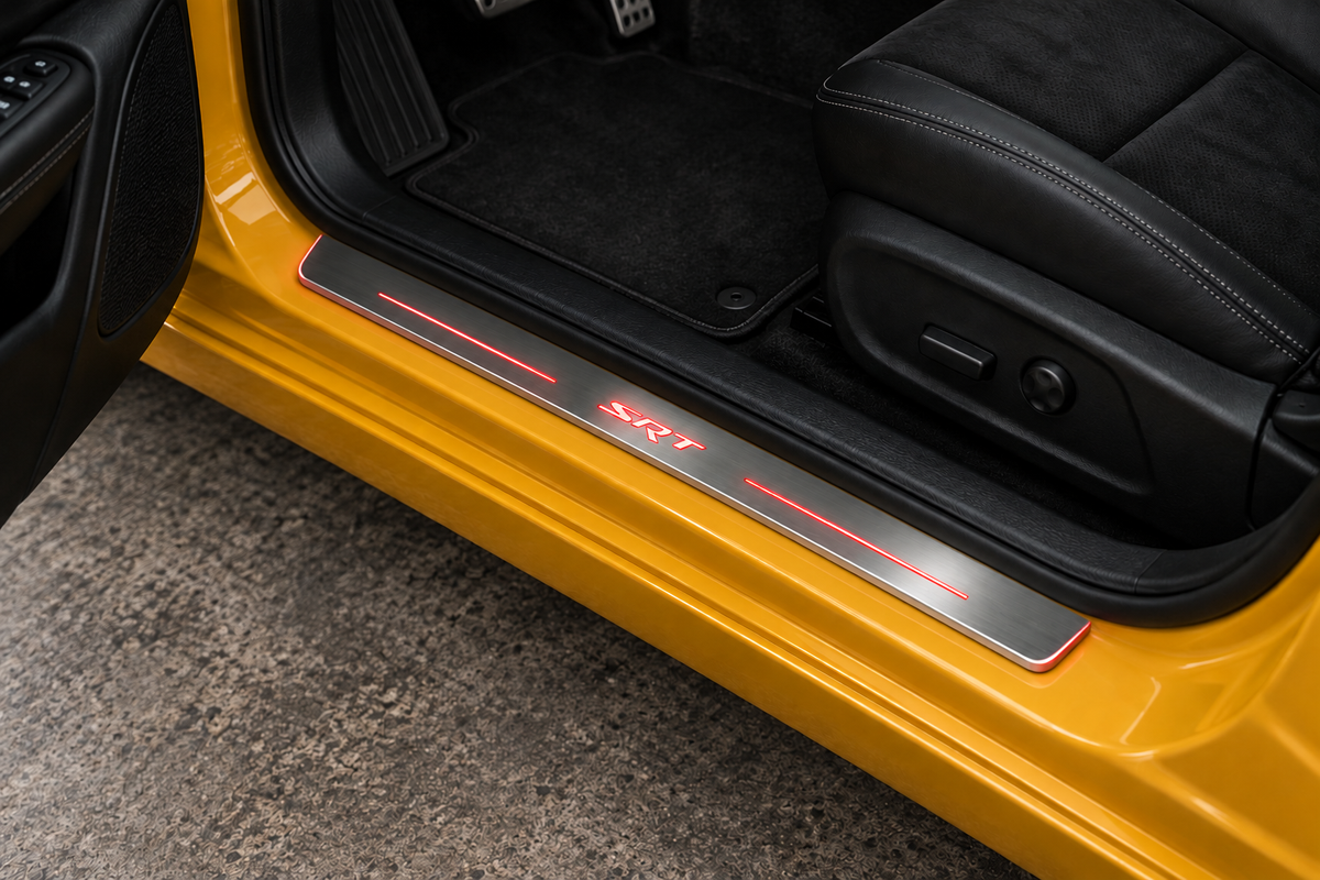 SRT Stainless sill on yellow painted metal directly against rubber seal; red SRT lettering, bars and thin edge illumination — product visualization