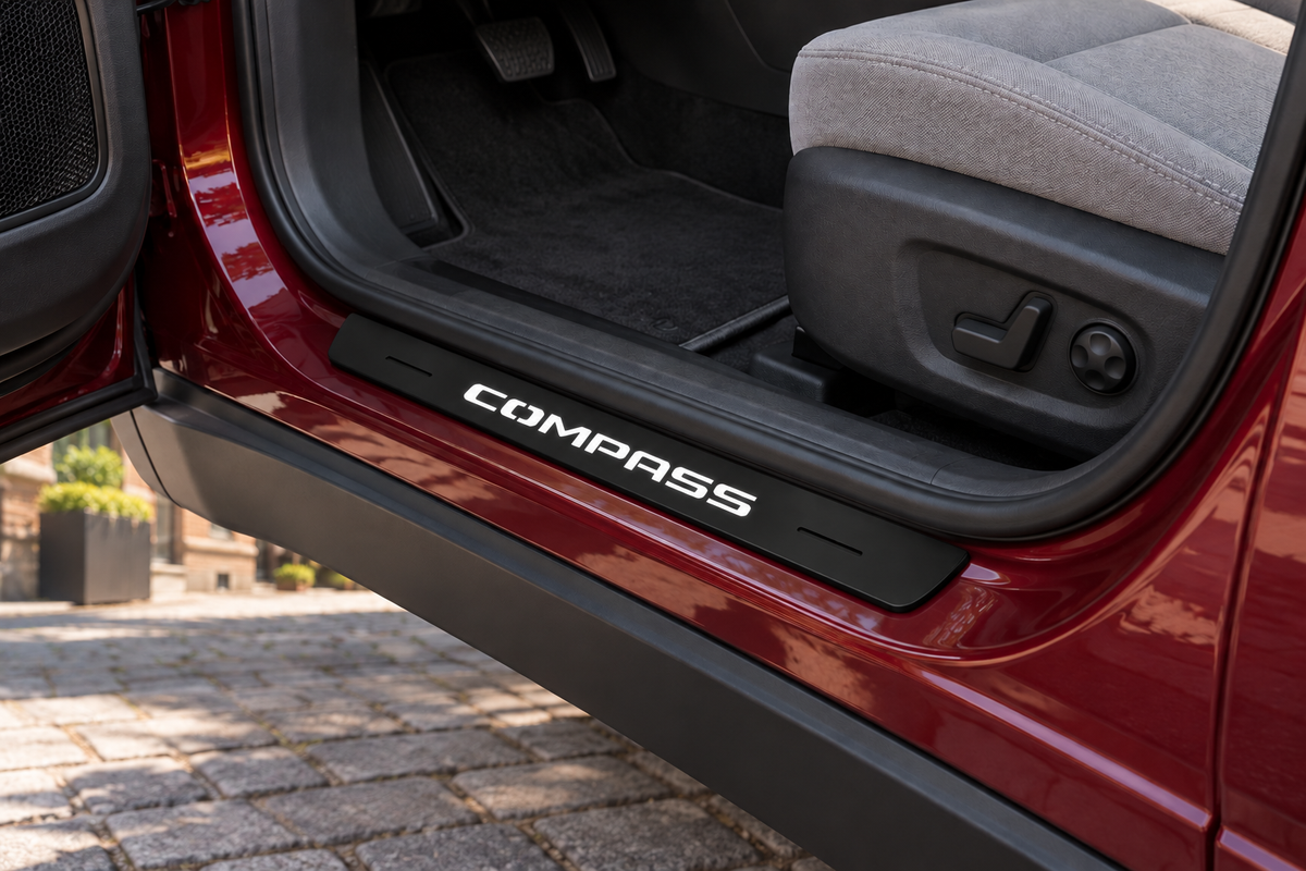Jeep Compass Matte PRO sill visualization, directly against the rubber seal on exposed burgundy metal; white COMPASS lettering and dark edges.