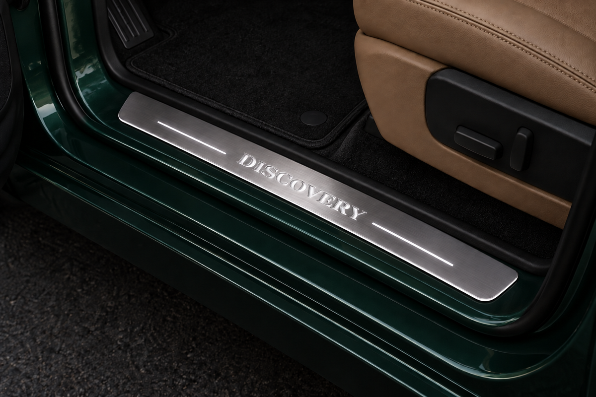 Discovery Stainless Steel sill on an exposed metal threshold, inner edge directly against the rubber seal — product visualization