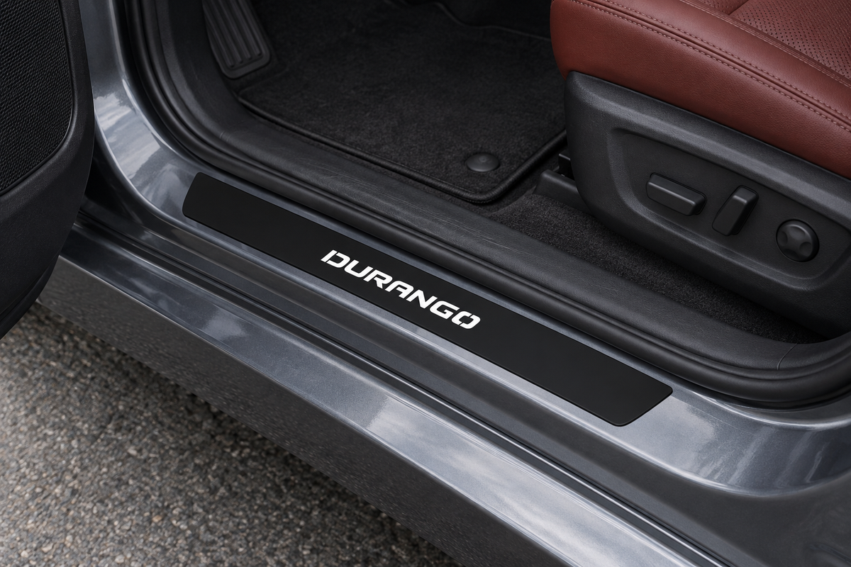 Product visualization of a black Matte PRO DURANGO sill on a grey SUV threshold, white lettering illuminated and edges unlit.