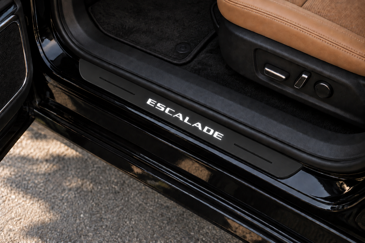 Cadillac Escalade Matte PRO sill visualization directly against the rubber seal on exposed black painted metal; white lettering, dark recessed lines and edges.