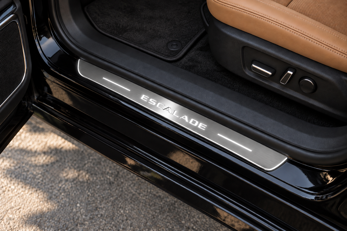 Cadillac Escalade Stainless sill visualization directly against the rubber seal on exposed black metal; white ESCALADE artwork, light bars and thin edge illumination.