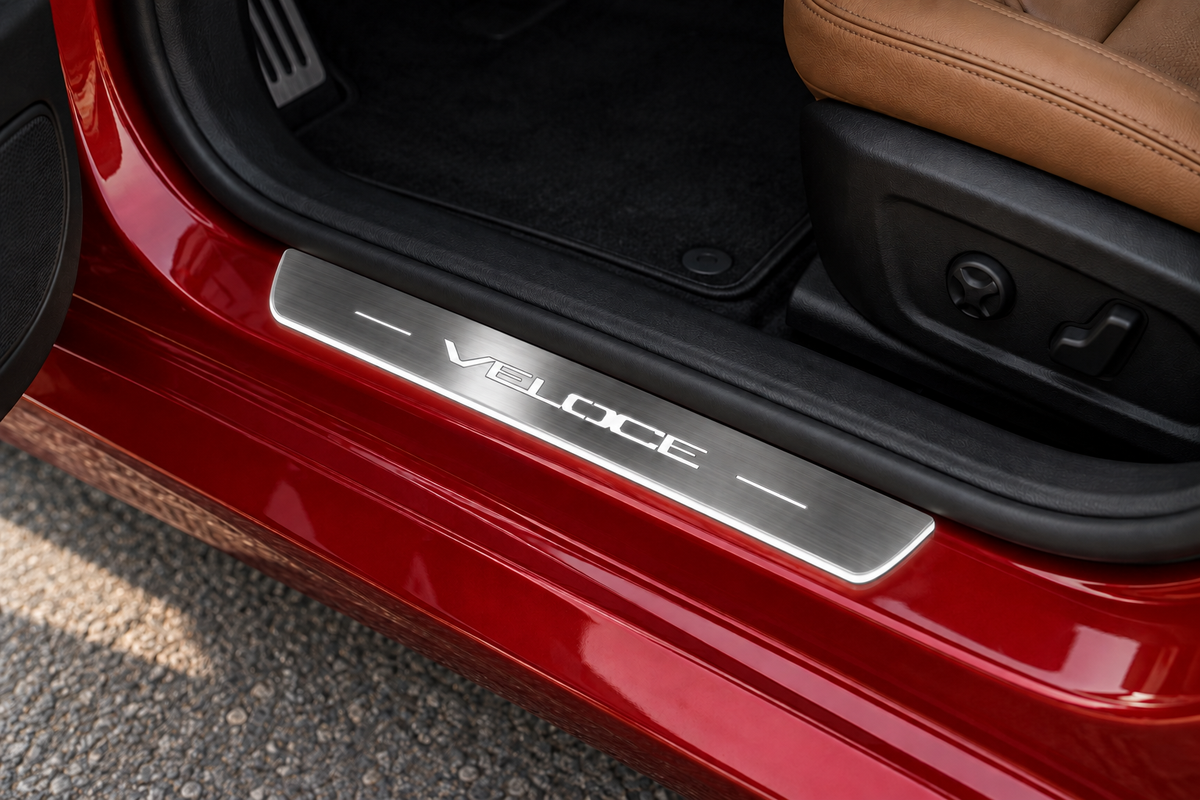 Alfa Romeo Giulia Veloce Stainless sill visualization directly against the rubber seal on exposed red metal, with VELOCE lettering, two bars and thin edge illumination.