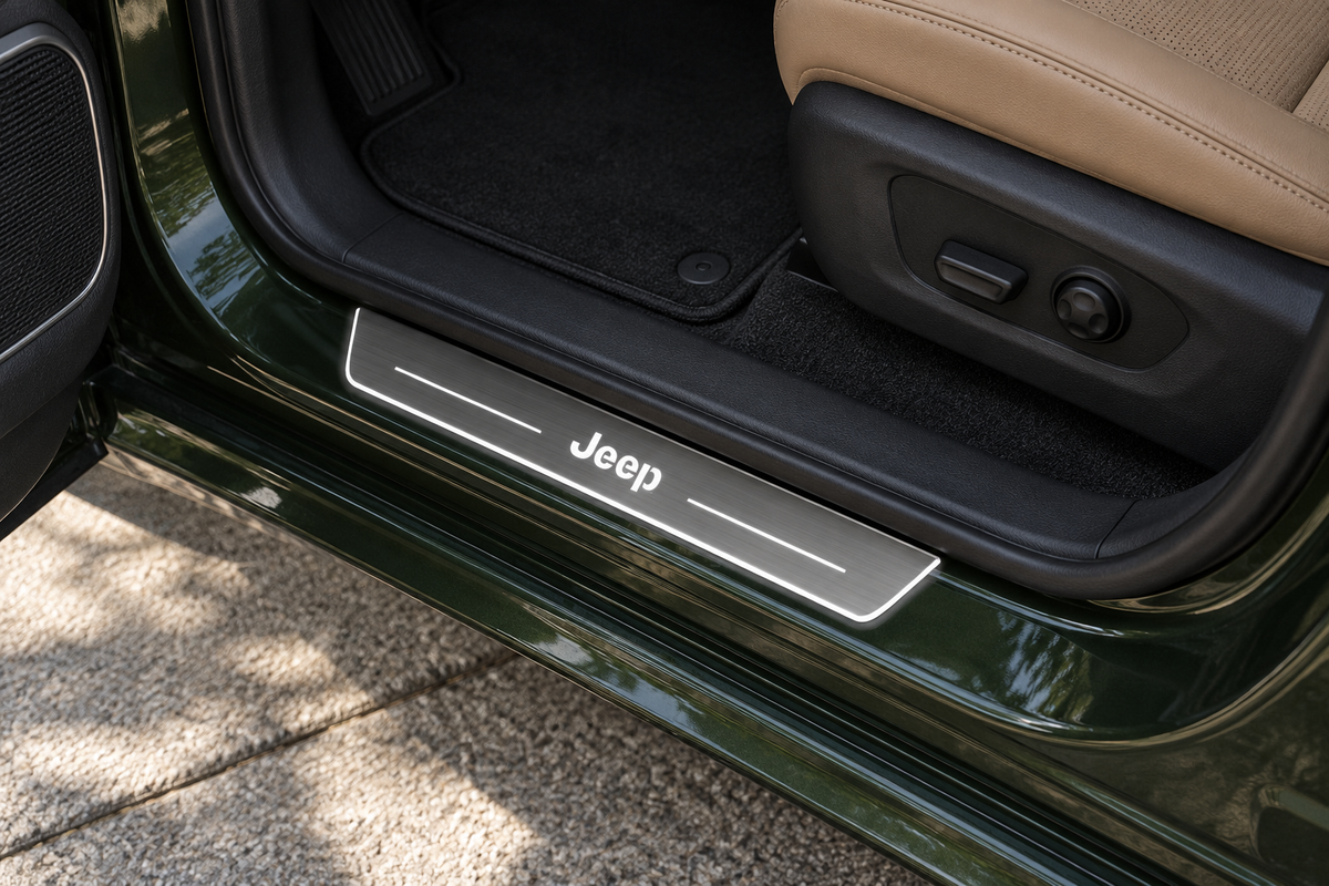 Product visualization of a grey brushed Stainless Steel sill with white Jeep lettering, two top light bars and a narrow illuminated edge in a green SUV doorway.