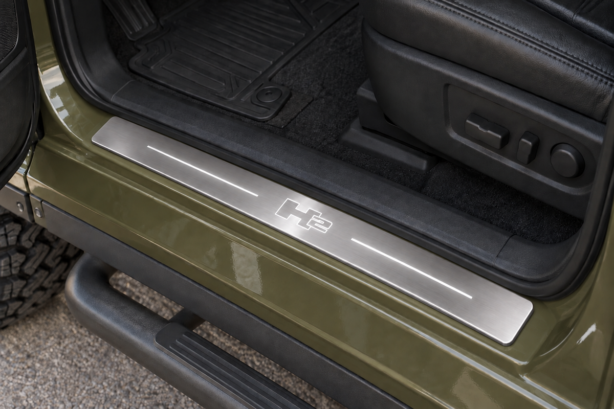 Hummer H2 Stainless sill visualization on olive painted metal, with its inner edge beside the rubber seal and H2 artwork illuminated in white.