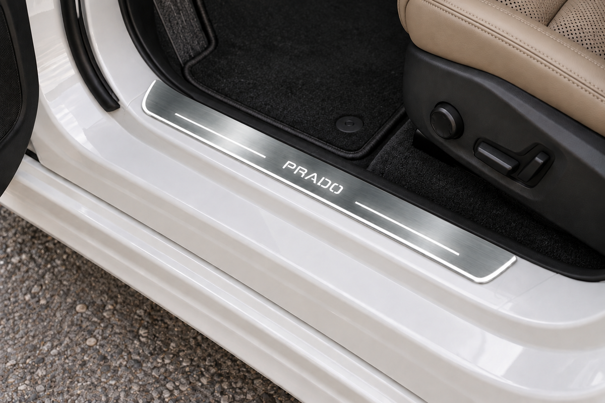Prado-logo Stainless sill on an exposed metal threshold directly beside the rubber seal — product visualization