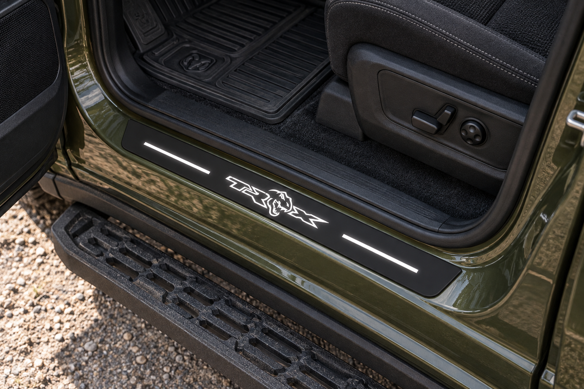 Product visualization of a black Matte PRO sill with white TRX dinosaur-head artwork and two top light bars in an olive pickup doorway; side edges remain unlit.