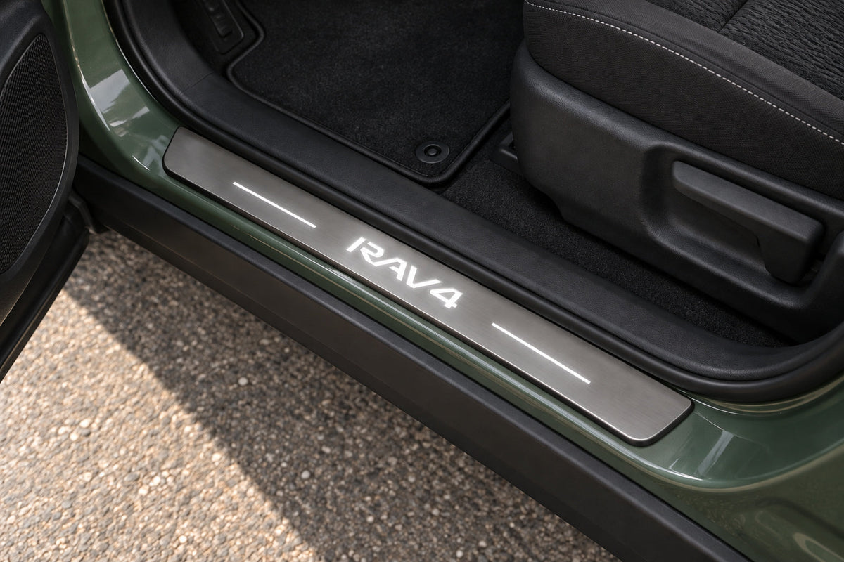Visualization of a brushed stainless RAV4 sill with white lettering and two light bars in a green SUV doorway.