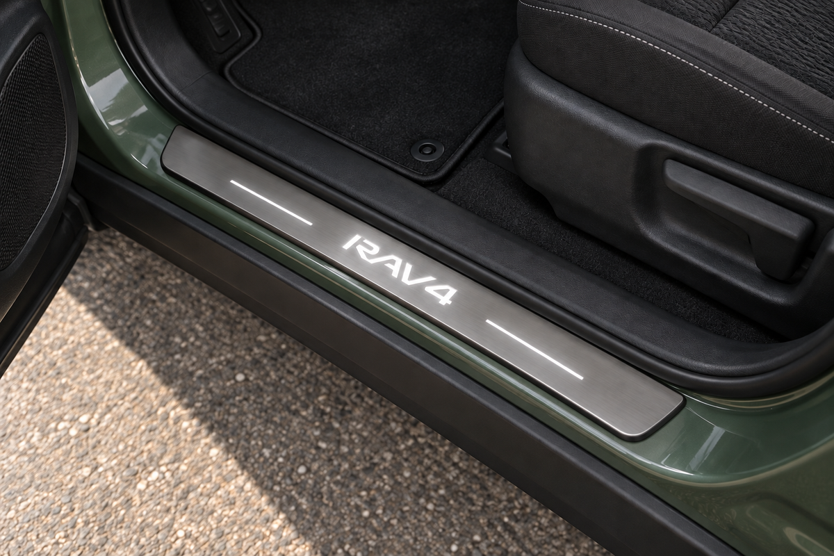 Toyota RAV4 XA50 Stainless Steel sill visualization with white RAV4 lettering and side lines on grey metal in a green SUV doorway.