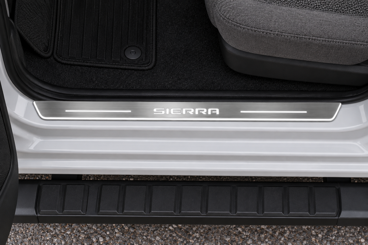 SIERRA Stainless LED sill on an exposed metal pickup threshold, inner edge directly against the rubber seal — product visualization
