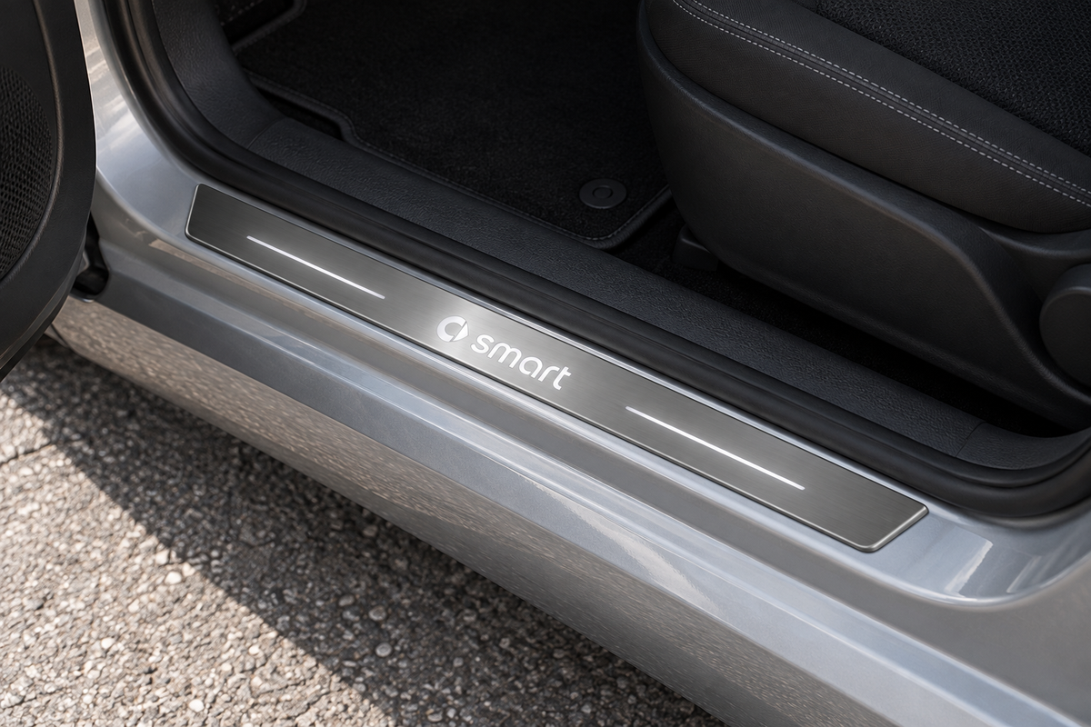 smart fortwo C453 Stainless Steel sill visualization, smart wordmark and emblem with white side lines on grey brushed steel in a silver city-car doorway.