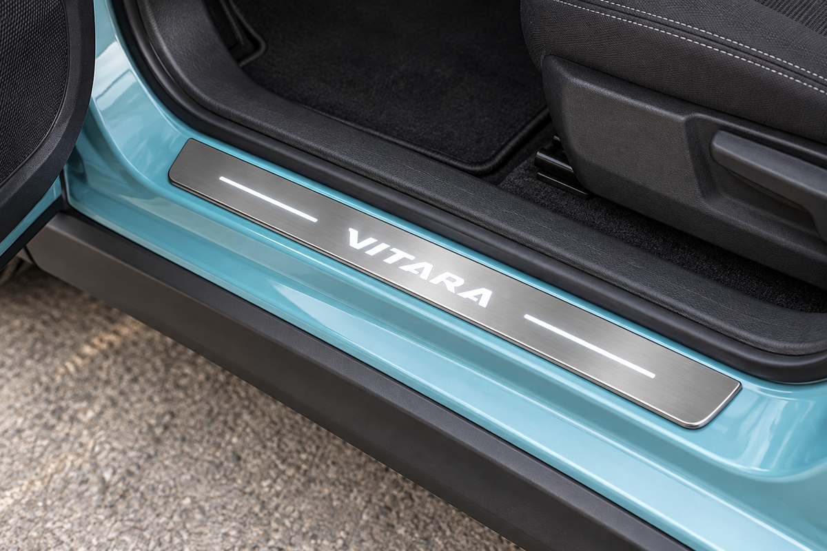 Suzuki Vitara Stainless Steel sill visualization with white italic VITARA lettering, side lines and edge on grey brushed steel in a turquoise crossover doorway.