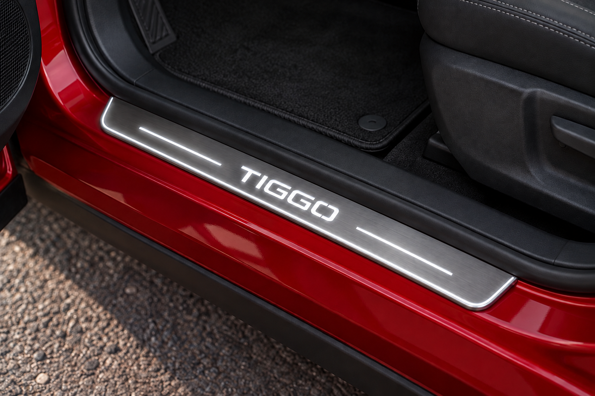 TIGGO Stainless sill on red painted metal directly against rubber seal; white lettering, bars and edge illumination — product visualization
