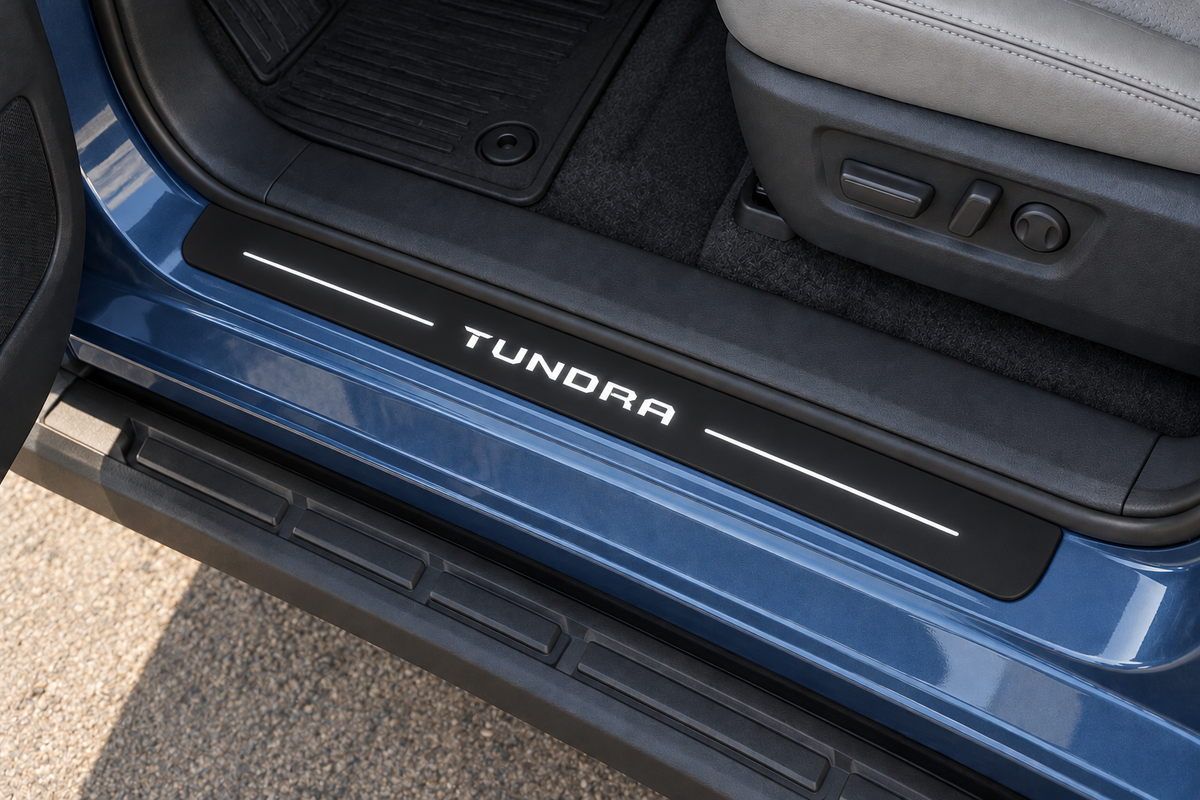 Toyota Tundra XK80 Matte PRO sill visualization directly against the rubber seal on exposed blue metal, white TUNDRA lettering and two top bars, dark edges.