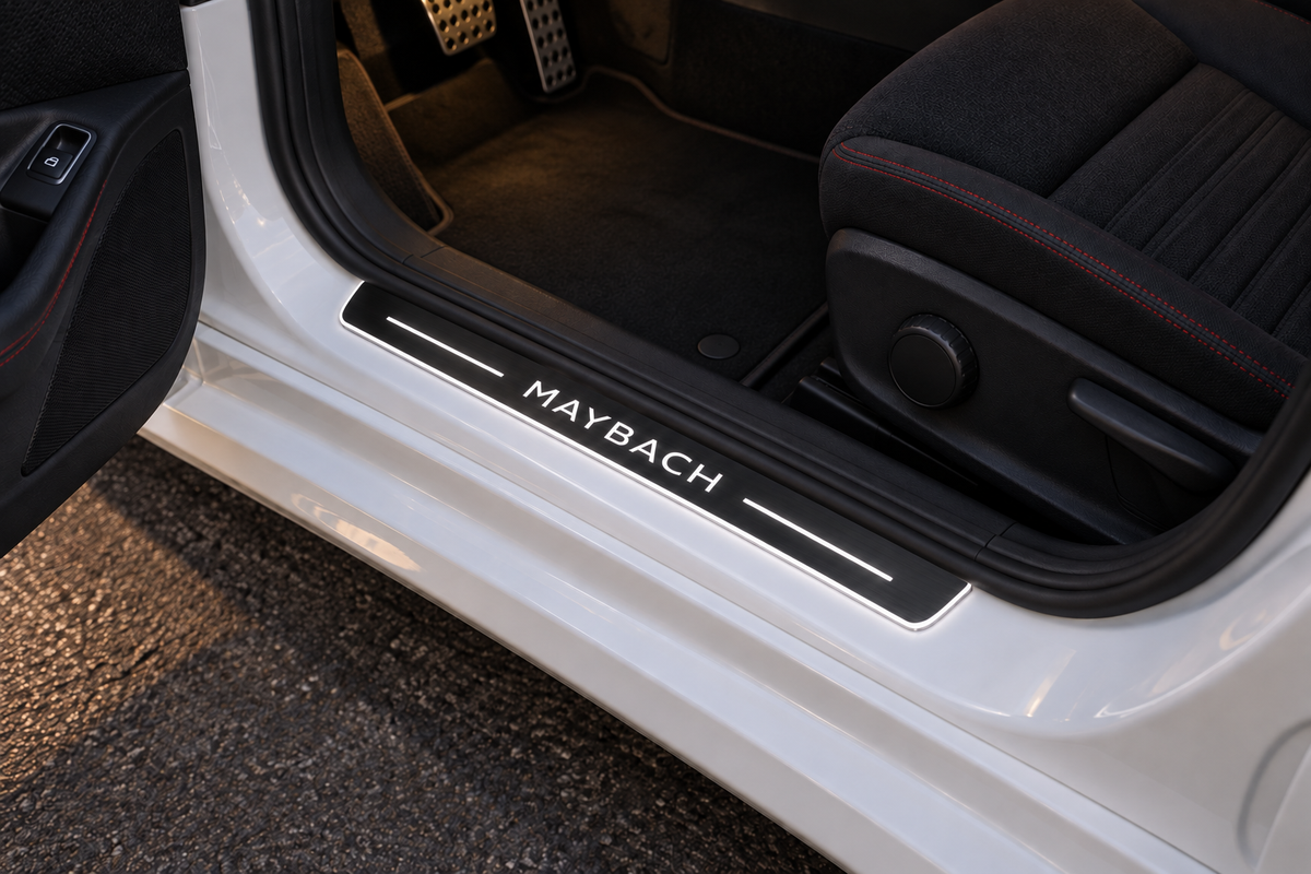 Mercedes W176 aftermarket Maybach-design Stainless sill visualization directly against the rubber seal on exposed white metal, MAYBACH lettering, two bars and thin Stainless edge illumination.