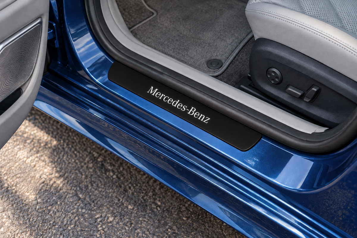 Mercedes-Benz W213 Matte PRO sill visualization directly against the rubber seal on exposed blue metal, white Mercedes-Benz lettering and dark edges.