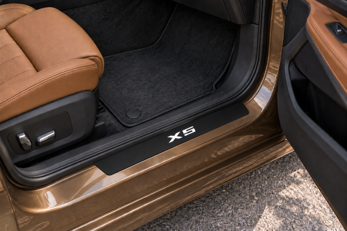 BMW X5 G05 Matte PRO sill visualization directly against the rubber seal on exposed bronze metal, white X5 lettering and dark edges.