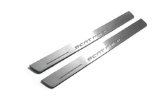 Two long silver-finished door sill plates with Scat Pack lettering on a light background, angled view.