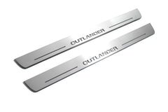 Two long silver-finished door sill plates with Outlander lettering on a light background, angled view.