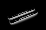 Toyota Prado 250 2023+ LED door sill plates in stainless steel with Land Cruiser logo