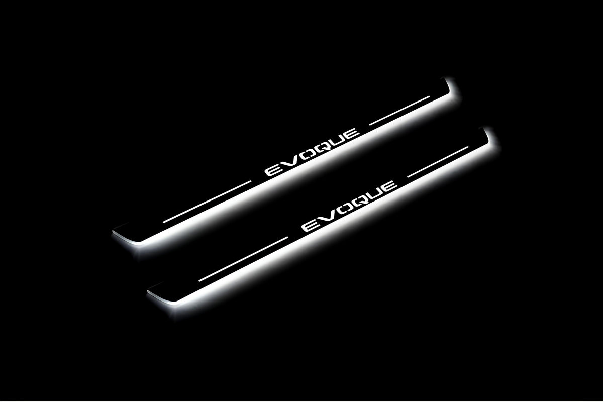 Two long door sill plates with Evoque lettering and edges illuminated in white, angled view on a dark background.