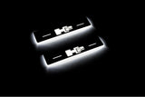 Two short door sill plates with H2 lettering and edges illuminated in white, angled view on a dark background.