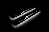 Two short door sill plates with A-Spec lettering and edges illuminated in white, angled view on a dark background.