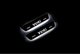 Two short door sill plates with Yeti lettering and edges illuminated in white, angled view on a dark background.