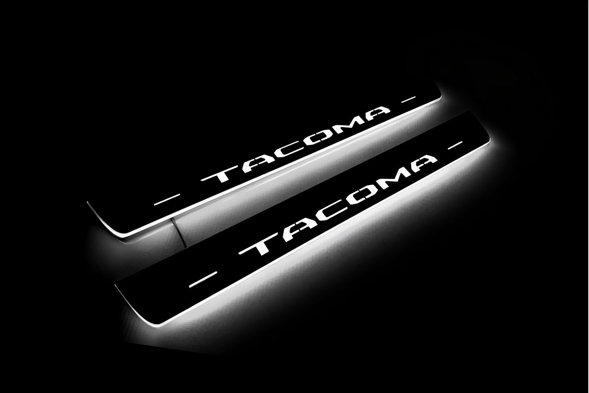 Toyota Tacoma III 2016+ LED door sill plates in stainless steel with Tacoma logo