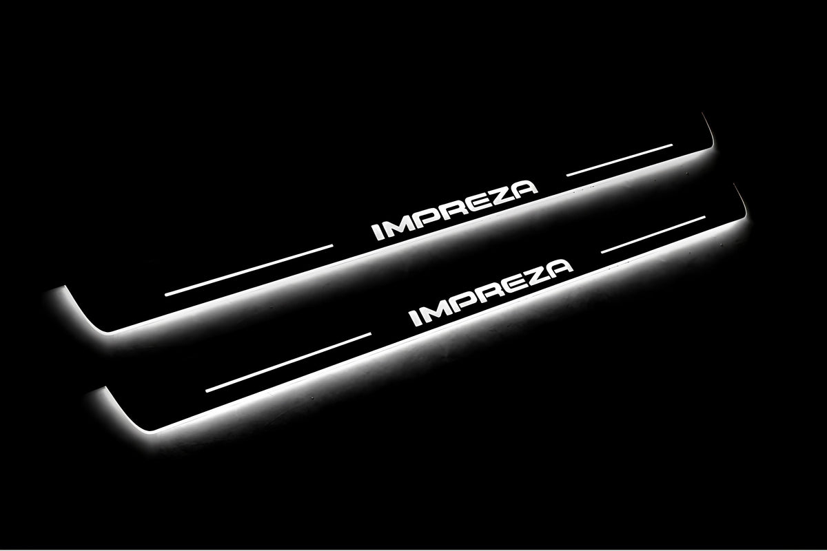 Two long door sill plates with Impreza lettering and edges illuminated in white, angled view on a dark background.