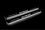 Two long door sill plates with Outback lettering and edges illuminated in white, angled view on a dark background.