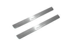 Two long silver-finished door sill plates with Tucson lettering on a light background, angled view.