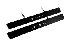 Two black door sill plates with white Infiniti lettering and visible wiring on a light background.