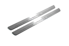 Two long silver-finished door sill plates with Vectra lettering on a light background, angled view.